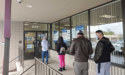 Customers wait in line outside the Secretary of State’s Lansing Branch