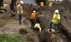 workers replacing pipe