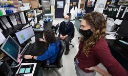 Dr. Heather Blankenship, foreground, Steve Dietrich, and Elizabeth Burgess track coronavirus variants at the Michigan Bureau of Laboratories in Lansing as the variants take hold in Michigan. 