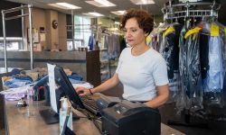 Becky Afendoulis Trierweiler checks in an order recently at Afendoulis Cleaners & Tuxedos in Grand Rapids. 