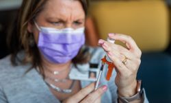 nurse holding vaccine