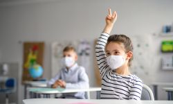 kids in masks in a classroom