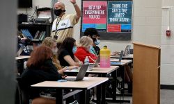 teacher in classroom. All wearing masks