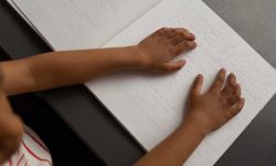 girl reading braille