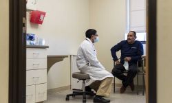 Dr. Sanjoy Mukerjee, left, meets with his patient Porfivio Alvarenga