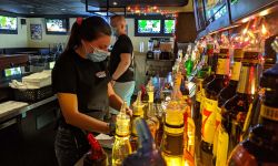 person in mask in bar