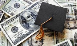 graduation hat on pile of money