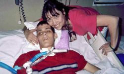 woman next to son on hospital bed