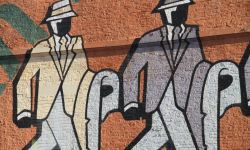 mural of two men walking 