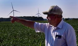 man with wind turbines in the background