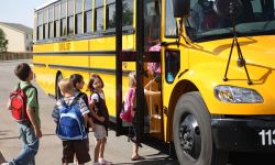kids getting on school bus
