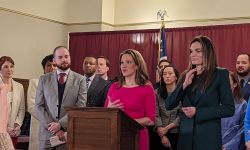 benson with a lot of people in the background at a press conference