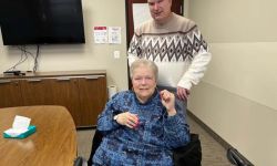woman in wheelchair and a man standing behind her