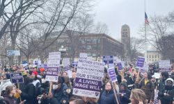 People protest in U-M Diag with signs