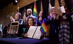 Gov. Gretchen Whitmer surrounded by people and pride flags