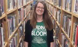 Patricia Buckhold flanked by book shelves