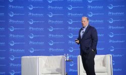 Detroit Mayor Mike Duggan on a stage with a blue background