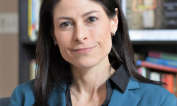 Michigan Attorney General Dana Nessel with bookshelf in background