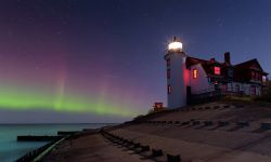 Northern Lights dancing in the night sky at Point Betsie Lighthouse, lake Michigan