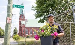 Tim Nutt holding a pot of flowers