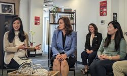 Gov. Gretchen Whitmer sitting down in a panel