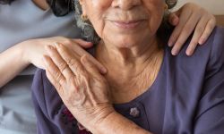 Woman comforts elderly woman