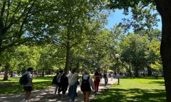 Students walk on the Drag