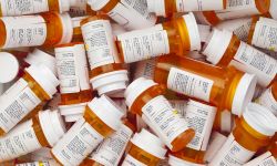 Dozens of prescription medicine bottles in a jumble