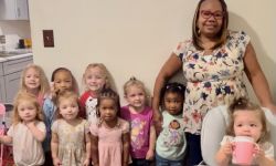 Kim Spivey standing next to children