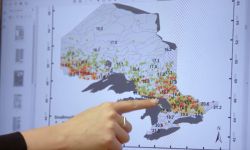 Karen Alofs at a map of the Great Lakes region