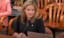 Michigan Secretary of State Jocelyn Benson siting at a table