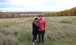 two people standing in a field