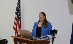 Stefanie Lambert speaking at a podium
