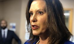 Michigan Gov. Gretchen Whitmer with a microphone in front of her