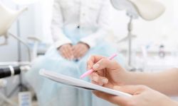 Young woman patient at gynecologist appointment consults in medical institution.