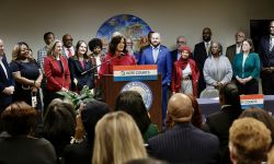 Michigan Gov. Gretchen Whitmer surrounded by lawmakers