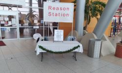 Table with a sign that says "Reason Station"