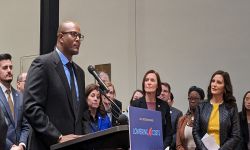 Joe Tate stands at a podium