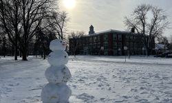 snowman in front; school in the background