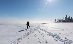 person walks on a frozen Lake Michigan