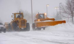 Snow plow busy clearing streets and roads during Winter season