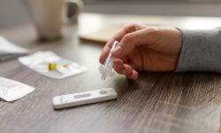  close up of woman making self testing coronavirus test at home