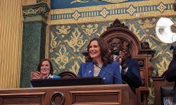 Gov. Gretchen Whitmer speaking into a microphone