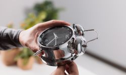 Male hand adjusting or changing the time on clock.
