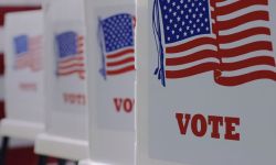 Voting booths line with US flag on the sides.