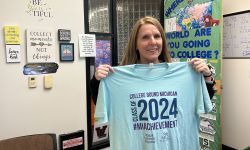  Kathy DeKeyser holding up a t-shirt for college bound students