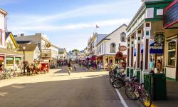 Vacationers take on Market Street on Mackinac Island that is lined with shops and restaurants.