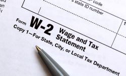 a pen lies on a W-2 form