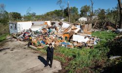 Man standing in front of a destroyed building in Portage, Michigan