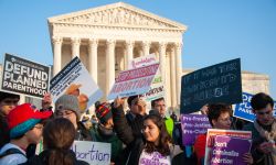 Protestors outside of the Supreme Court with pro and anti abortion signs